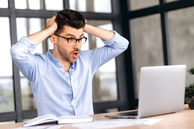 shocked man at laptop