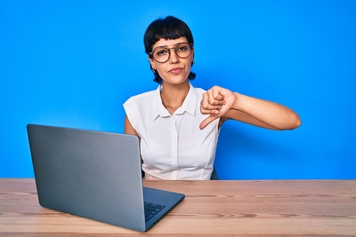unhappy woman laptop thumbs down